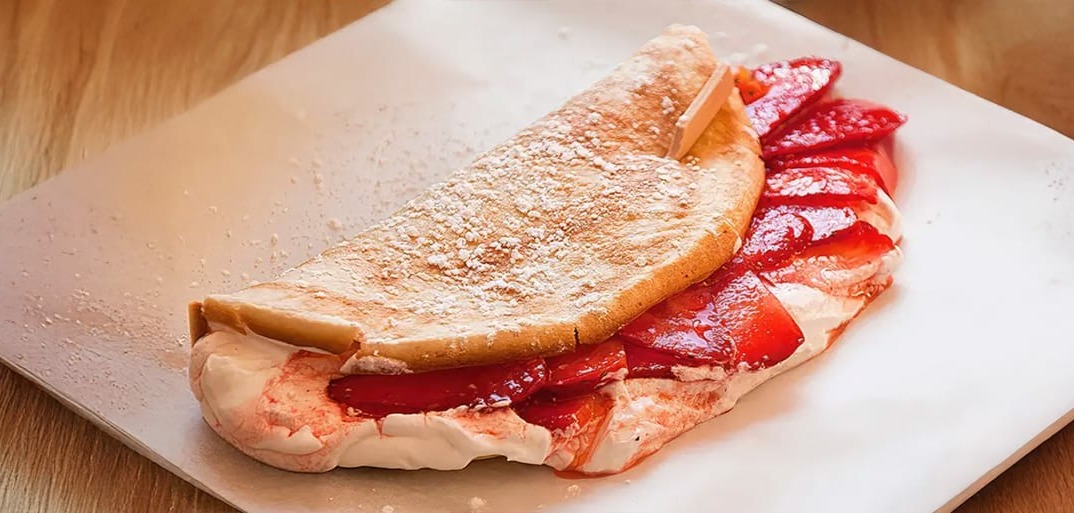 Sweet strawberry omelet – a light and fluffy omelet filled with fresh strawberries for a fruity dessert.