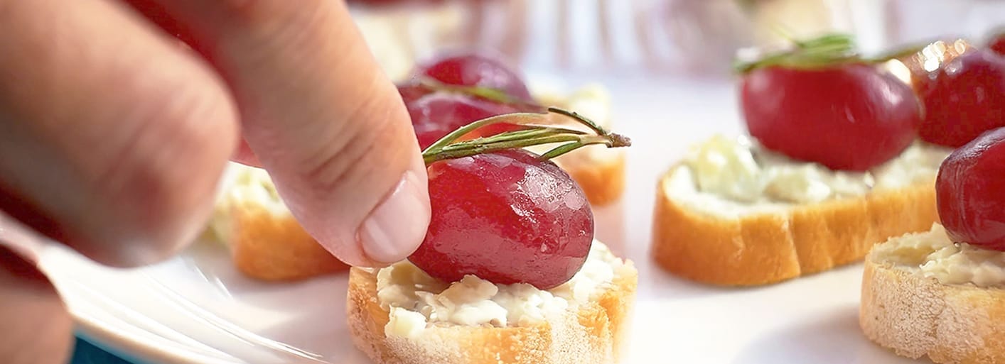 Roasted grape crostini with creamy cheese and herbs – a gourmet appetizer with a sweet and savory twist.