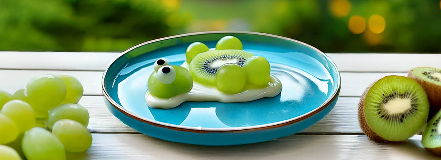 A playful plate of turtle-shaped snacks, made with green grapes, kiwi slices, and white chocolate